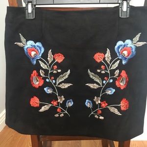 Thick embroidered and form fitting skirt.